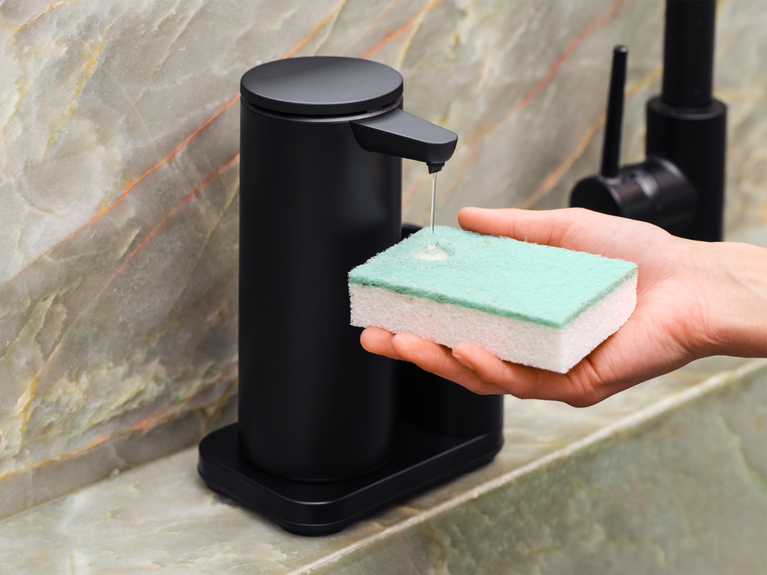 Simplehuman's Sensor Pump Dish dispensing soap onto a sponge. 