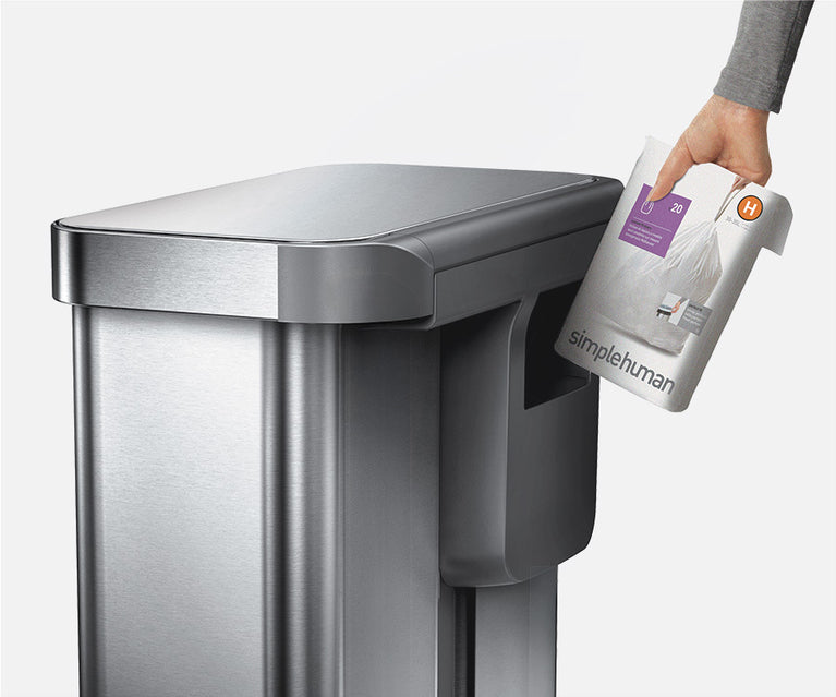 Simplehuman's Code H Liner sliding in the back liner pocket.