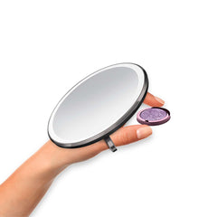 sensor mirror compact 3x - black finish - hand holding makeup image